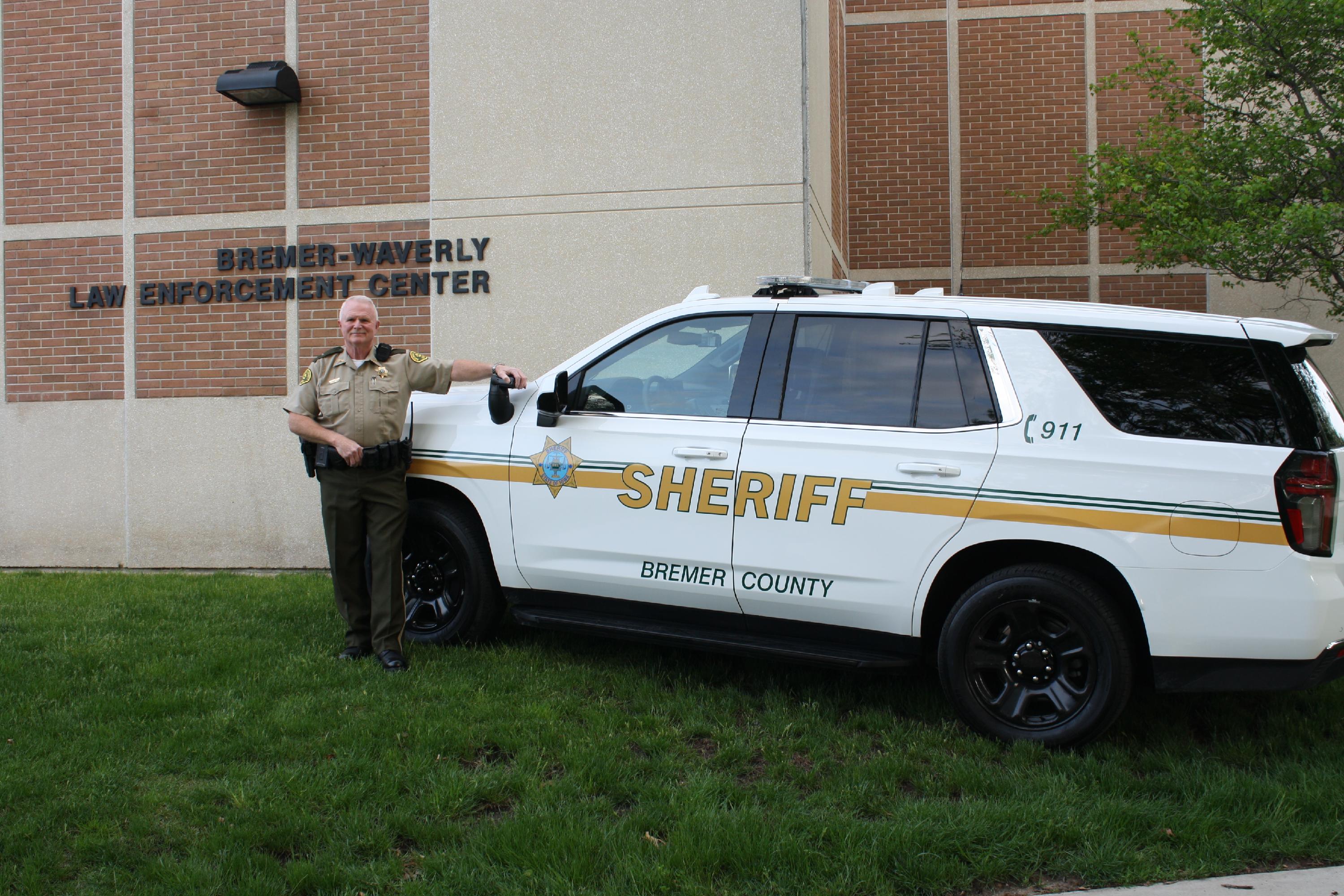 Sheriff Pickett standing beside a patrol car