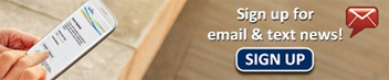 Hand holding a smartphone next to a sign-up banner that reads ‘Sign up for email & text news!’ with a sign-up button.